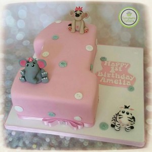 Number 1 pink birthday cake with zebra, elephant and tiger
