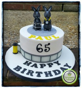 Retirement / 65th cake with black rabbits, camera & Zimmer frame
